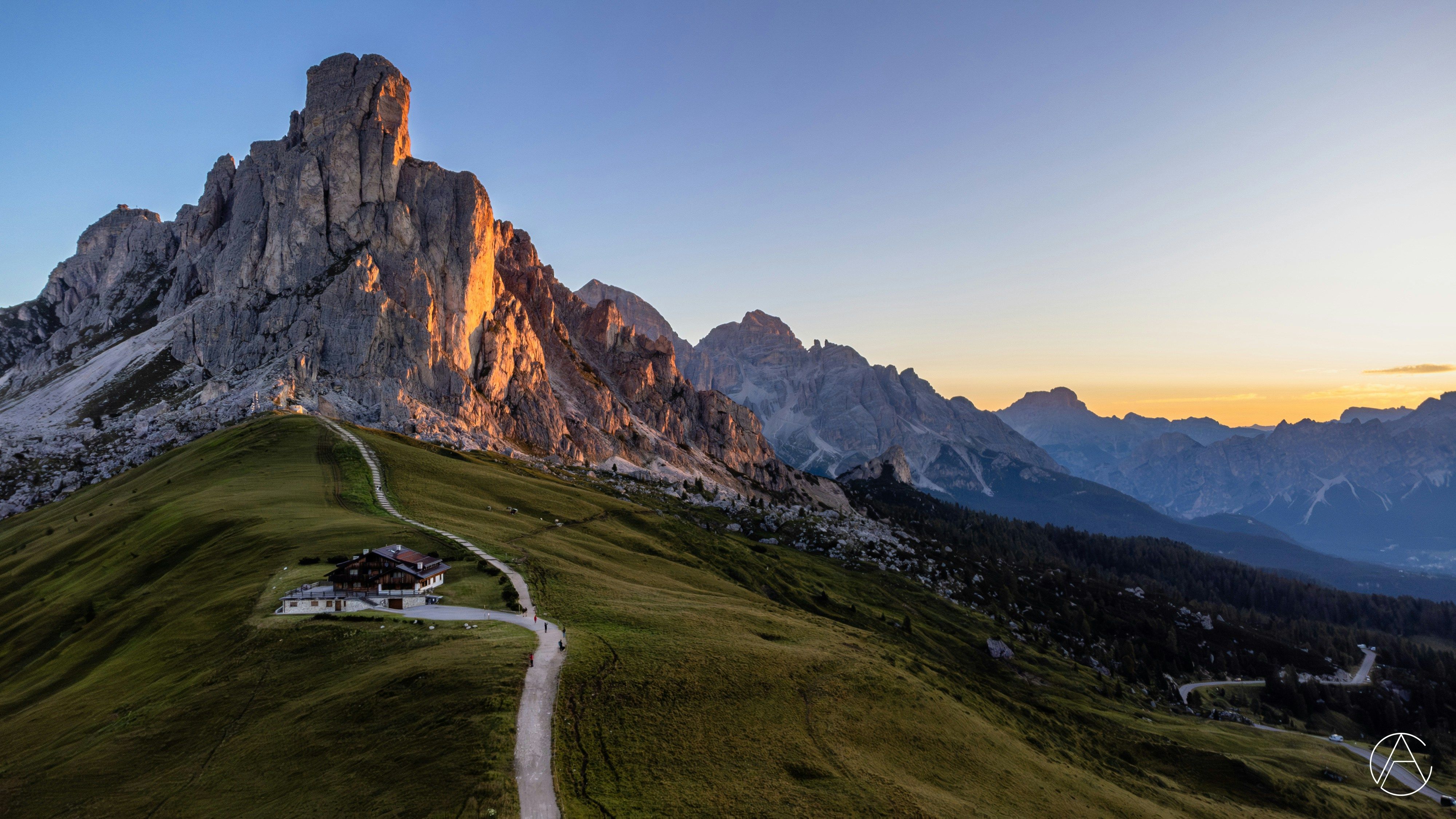 The road climbing Passo Giau in the Dolomites at sunset.